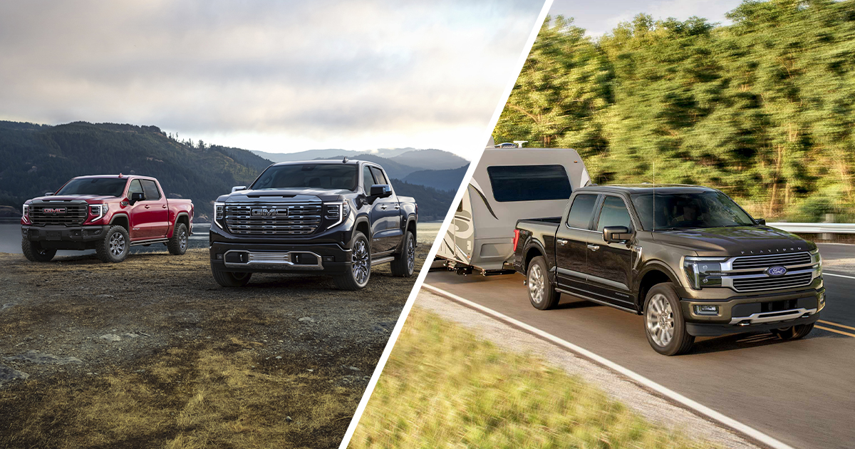 Comparison shot of 2 GMC Sierra 1500 models and a Ford F-150 on driving on a highway.