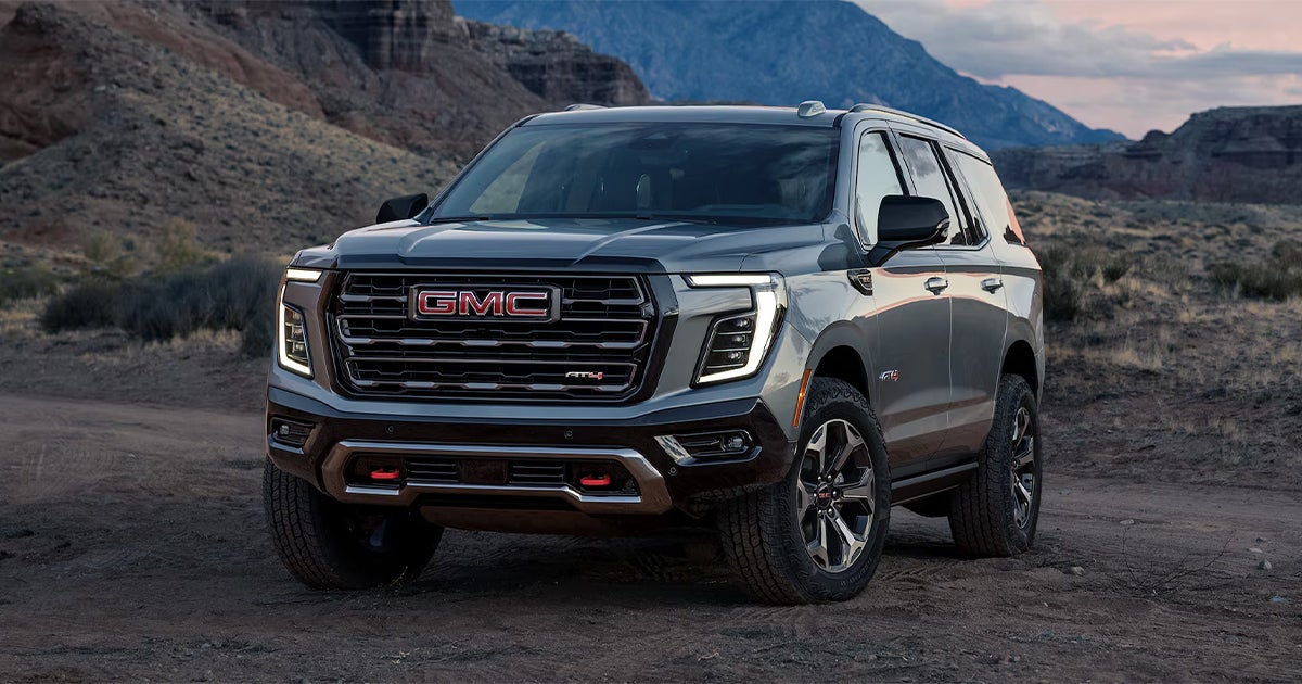 A GMC Yukon with a mountain backdrop